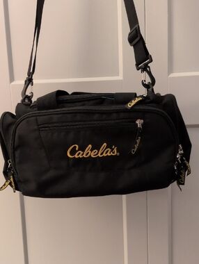 Cabela's Black Duffel Bag with Gold Logo and Adjustable Strap